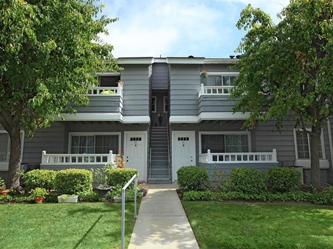 View of building entrance with view of patios and balconies