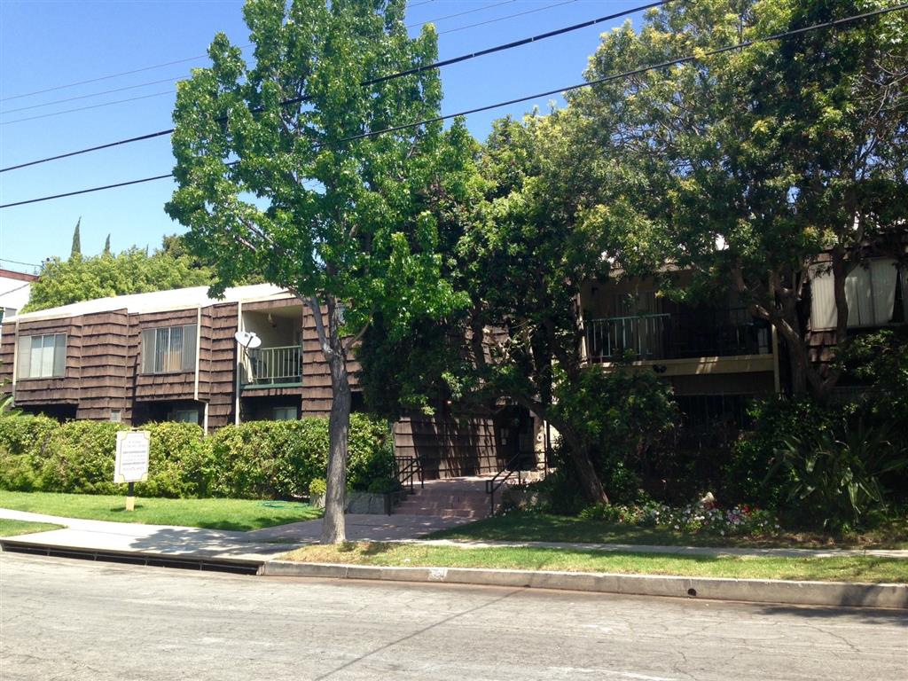Street view of property with foliage