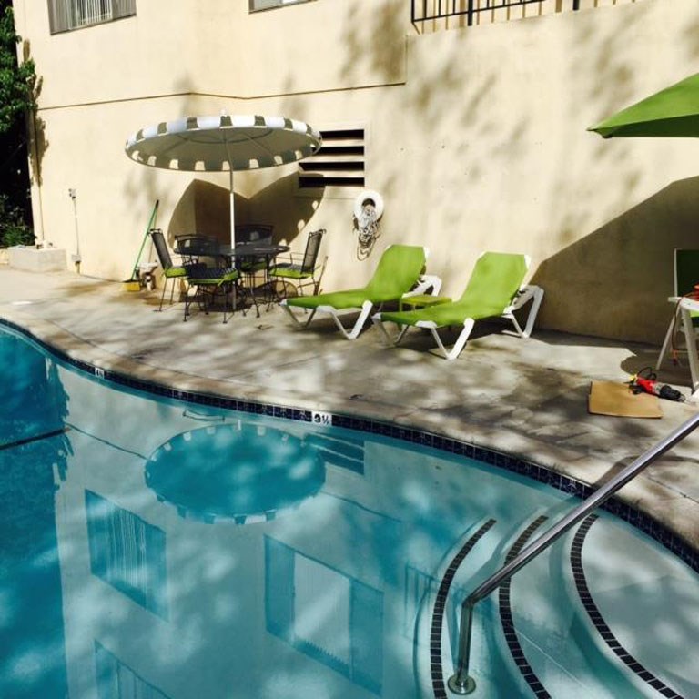 View of swimming pool with pool furniture