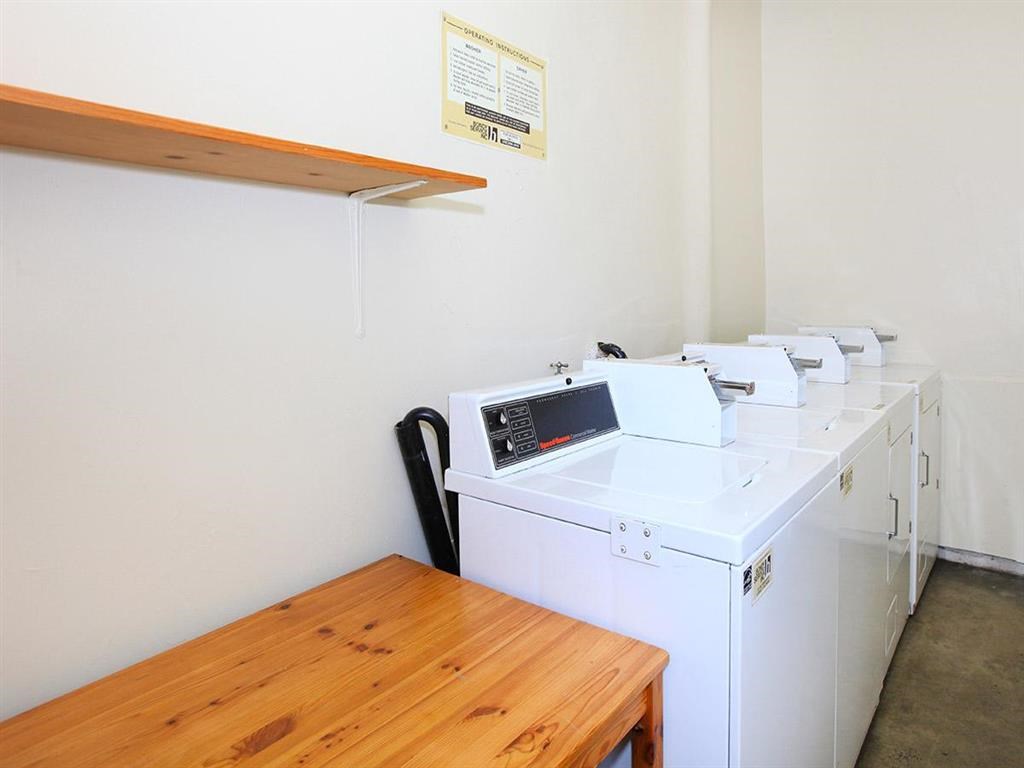 Laundry room with wooden table