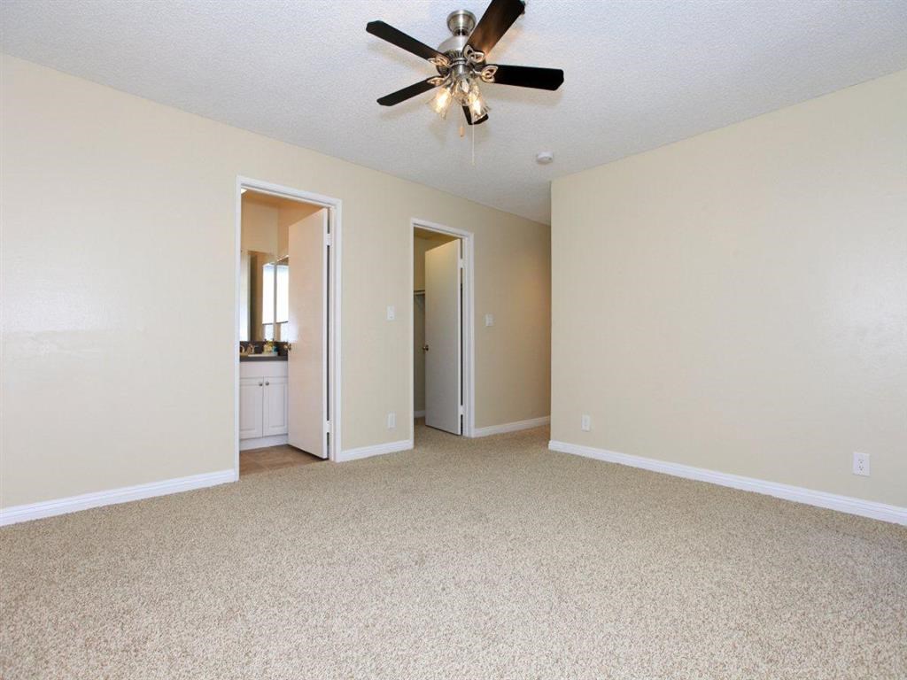 Common area with ceiling fan and carpeted floors