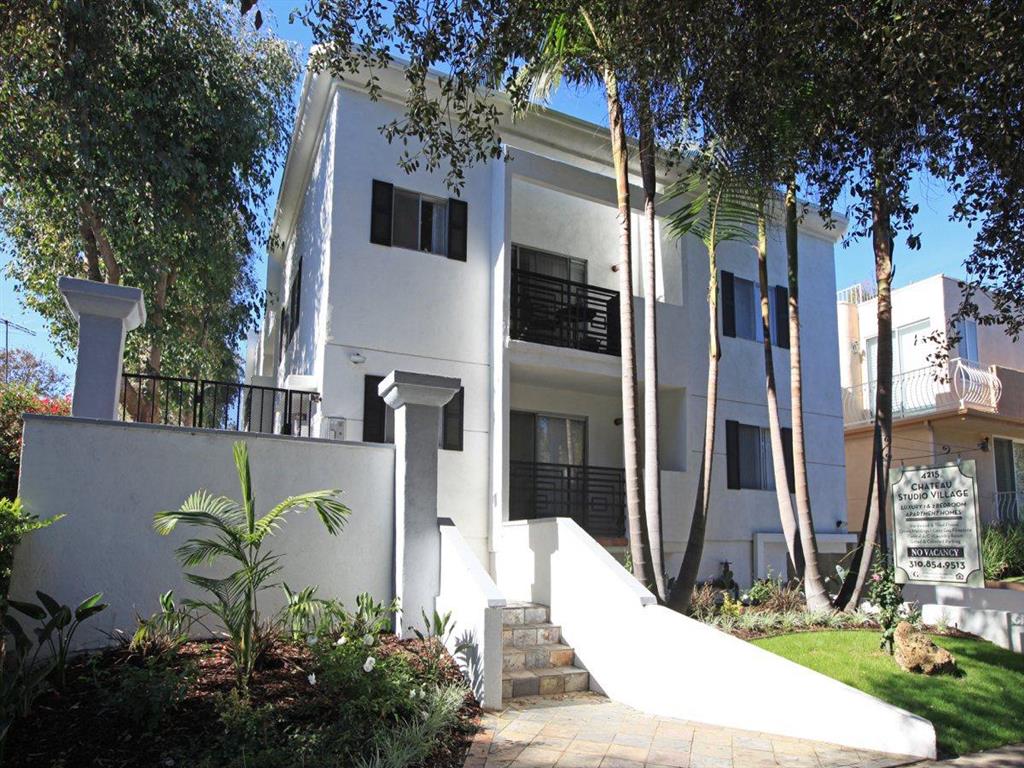 front of building with a garden and stairs to the building