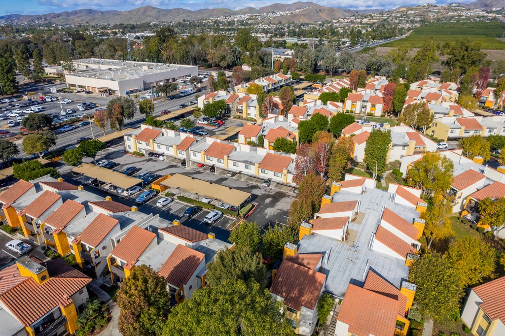 an aerial view of a neighborhood of houses with orange roofs