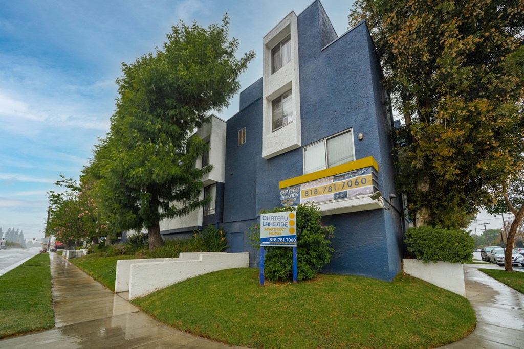 a blue building with a yellow and white sign in front of it