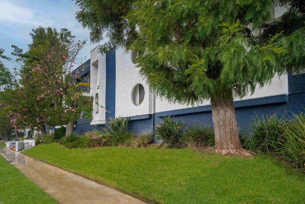 Front of the Building with trees and lawn.