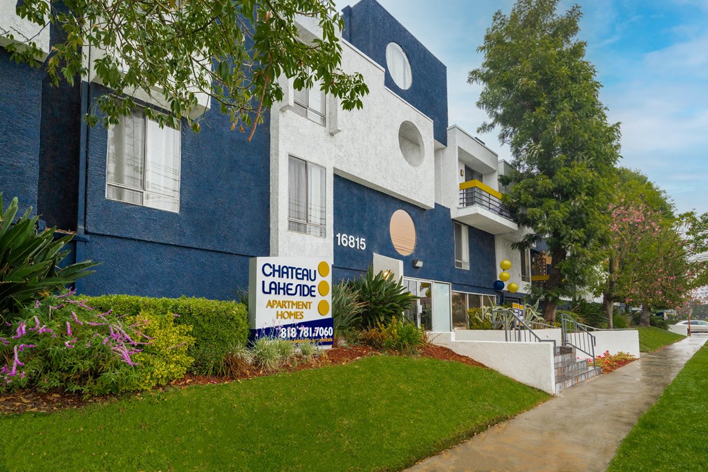 a blue and white building with a yellow and white sign in front of it