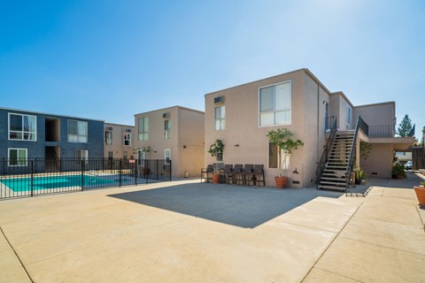 a row of apartments with a swimming pool and a staircase