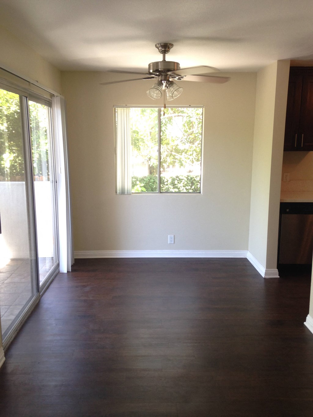 A room with a ceiling fan and a window.