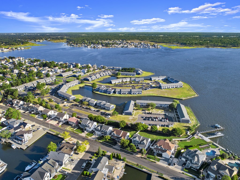 an aerial view of a residential neighborhood near a body of water and a lake