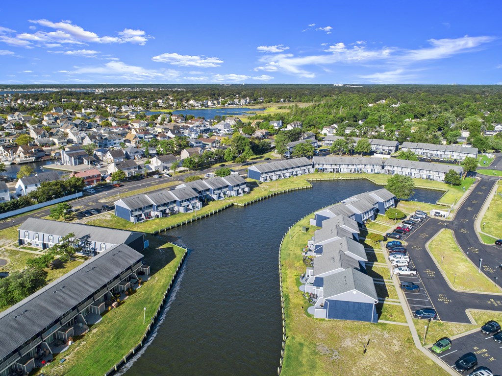 an aerial view of a neighborhood with a body of water