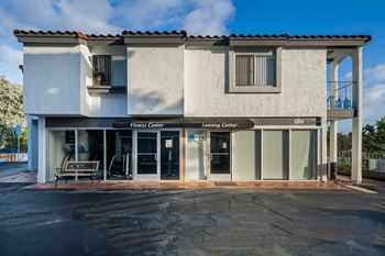 a white building with a bench in front of it