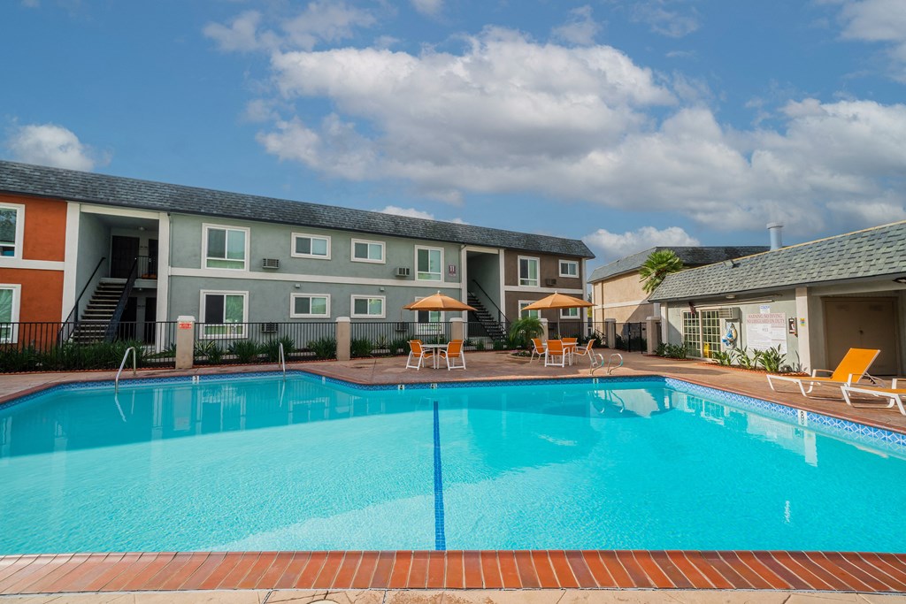 a swimming pool with a building in the background