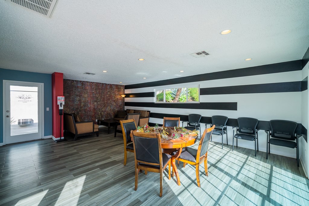 a dining room with a table and chairs and a wall with black and white stripes