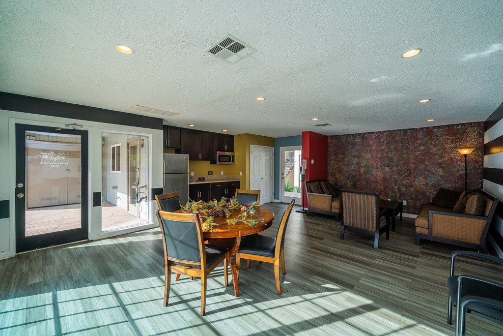 a dining room and living room with a table and chairs