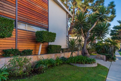 A modern house with a well-maintained garden in front.