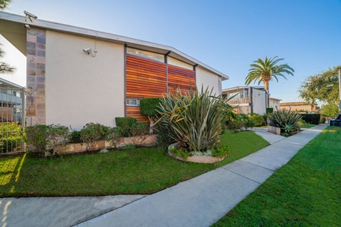 A modern house with a red and orange garage door.