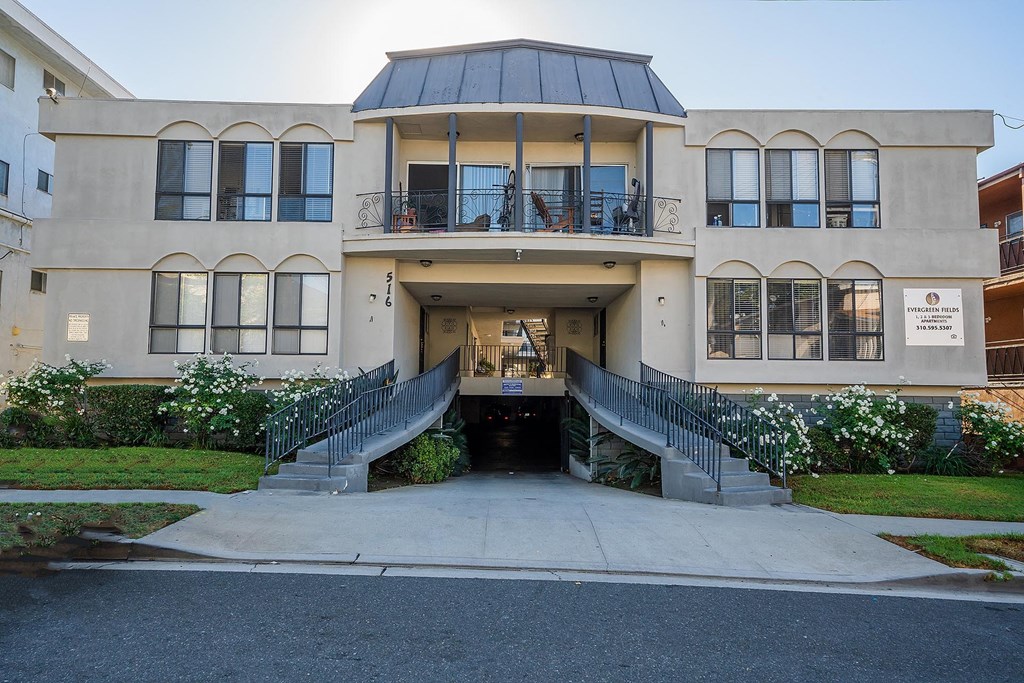 A large building with a balcony and a glass roof.