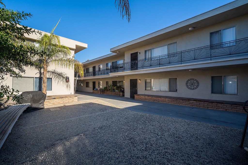 A sunny day at a residential complex with a clear blue sky.