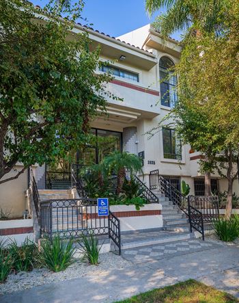 A building with a blue handicap sign in front of it.