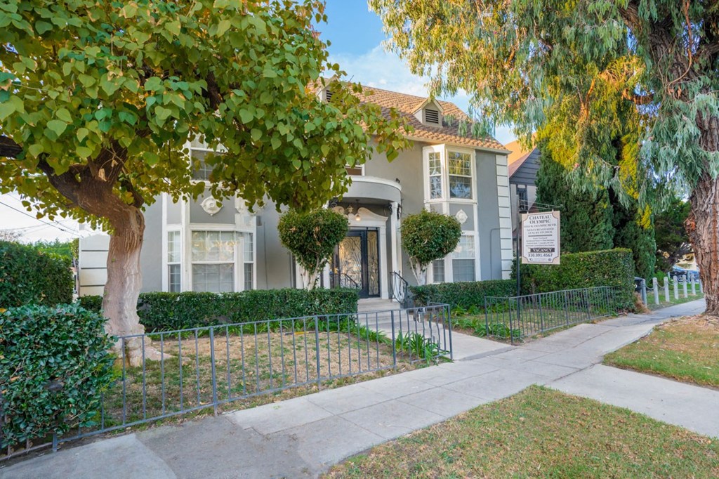 A house with a tree in front of it.