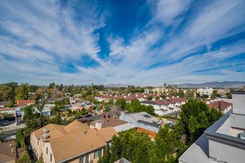A view of a residential area with houses and trees.