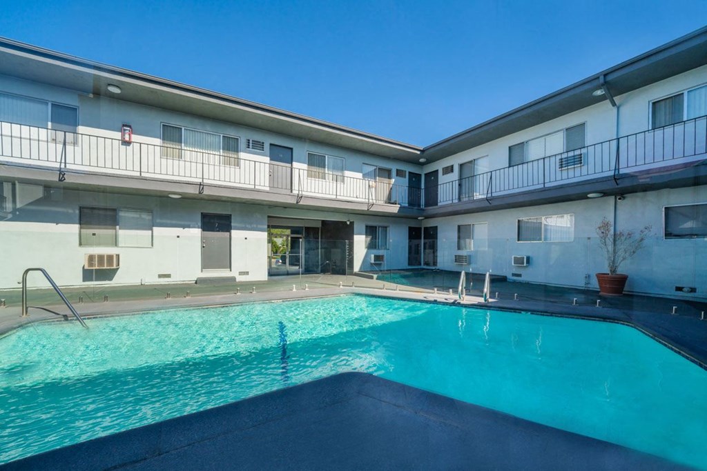 a swimming pool with a blue sky in the background