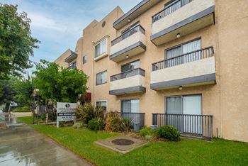 The image shows a multi-story building with balconies and a sign in front that reads "Chapel Hill Apartments."