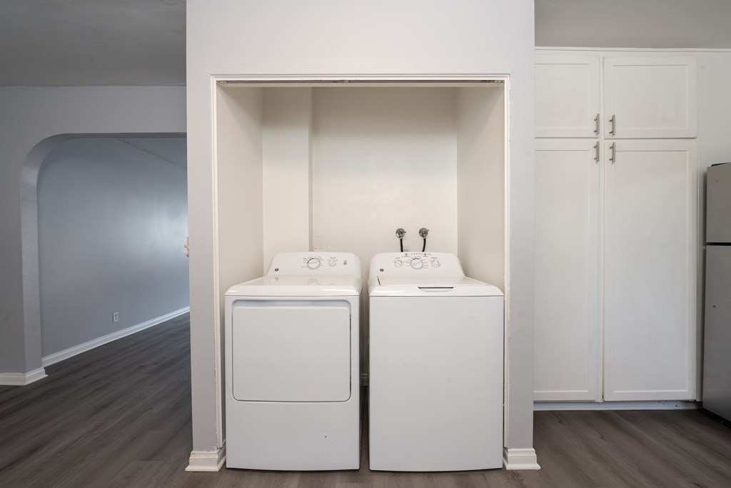 A white laundry room with a washer and dryer.
