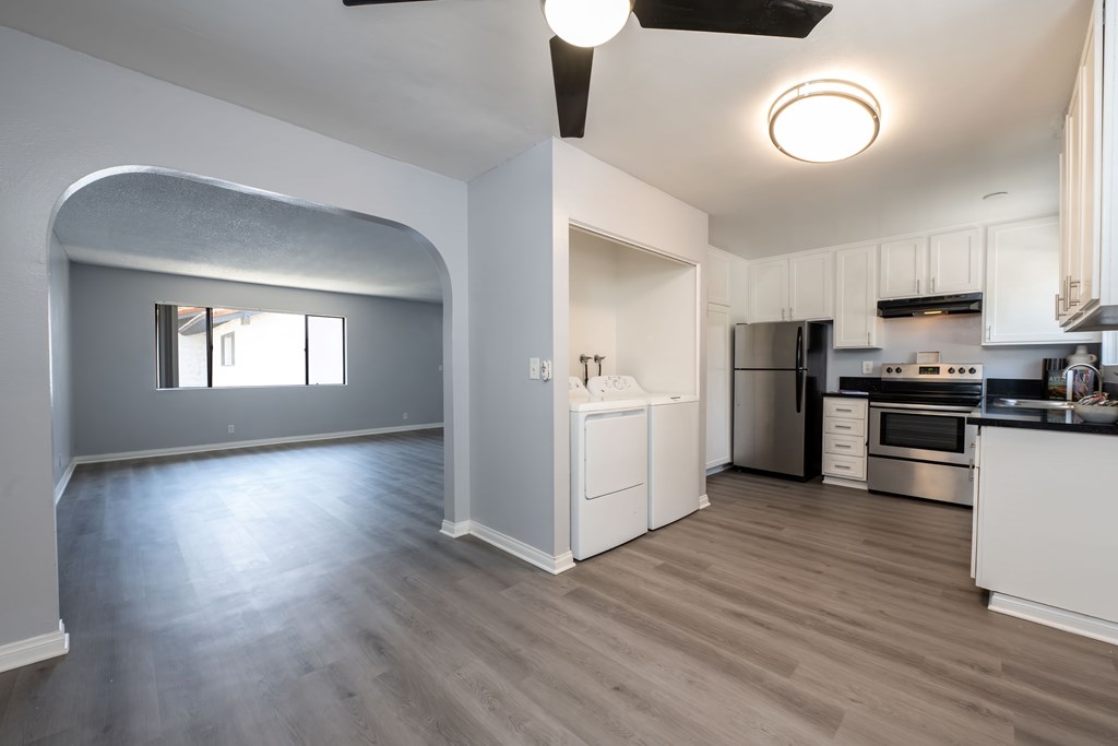 A modern kitchen with a large island and stainless steel appliances.