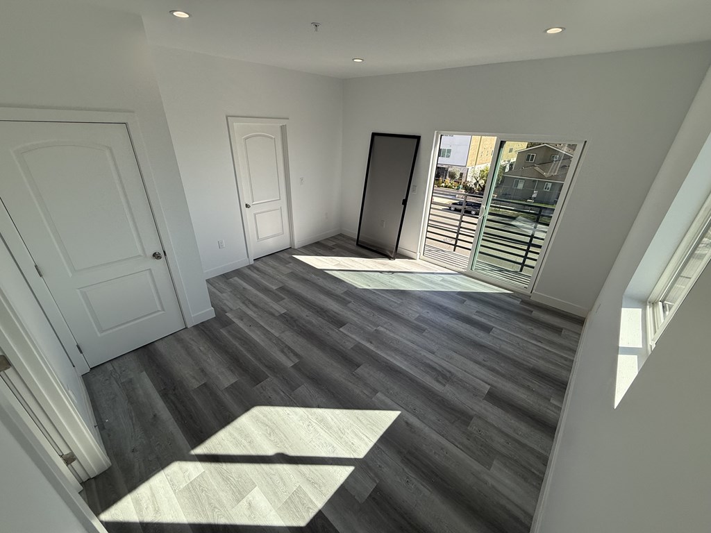 A room with a wooden floor and white walls.