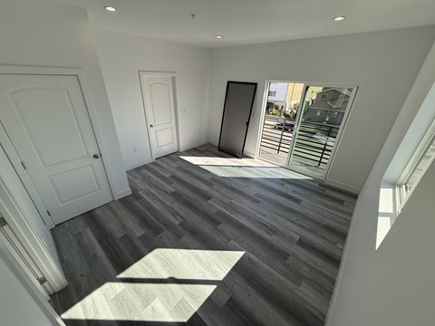 A room with a wooden floor and white walls.