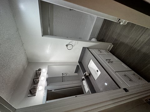 A view of a stairwell with a metal railing and a light on.