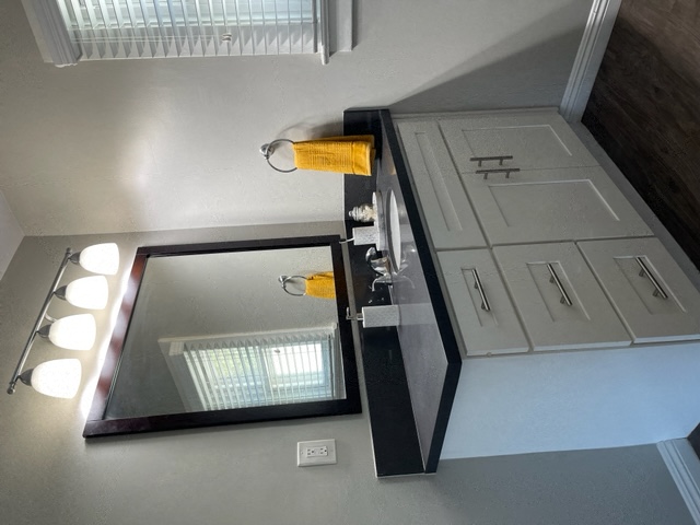 a bathroom with a mirror and a sink