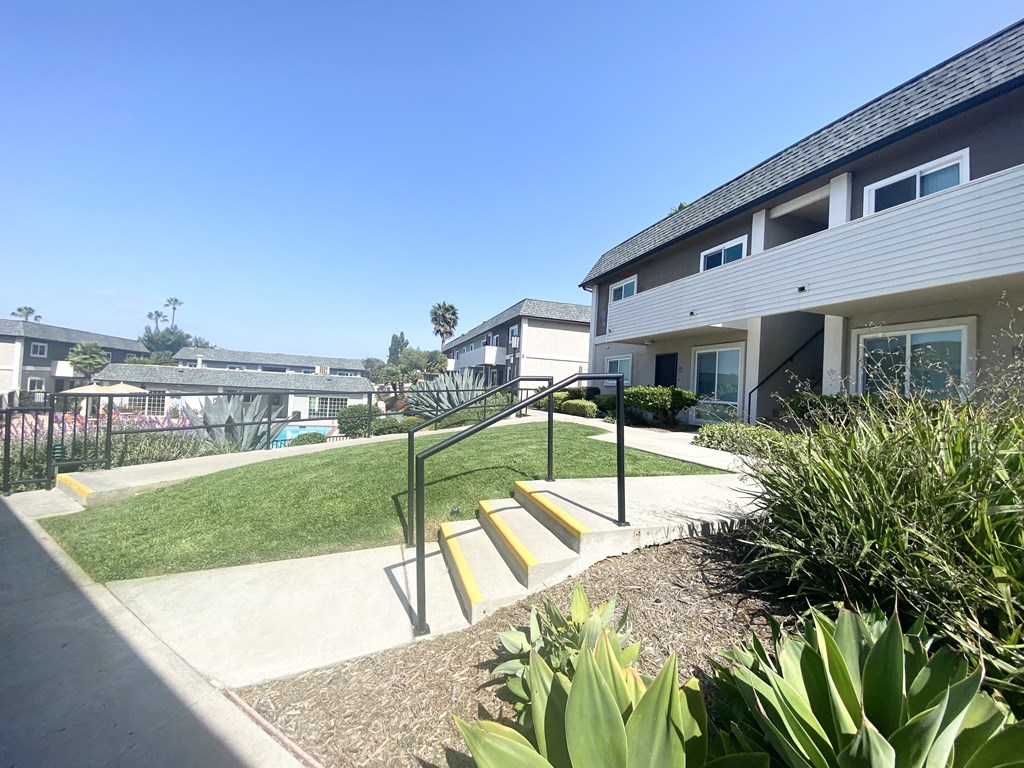 a stairway leading up to a house with yellow steps