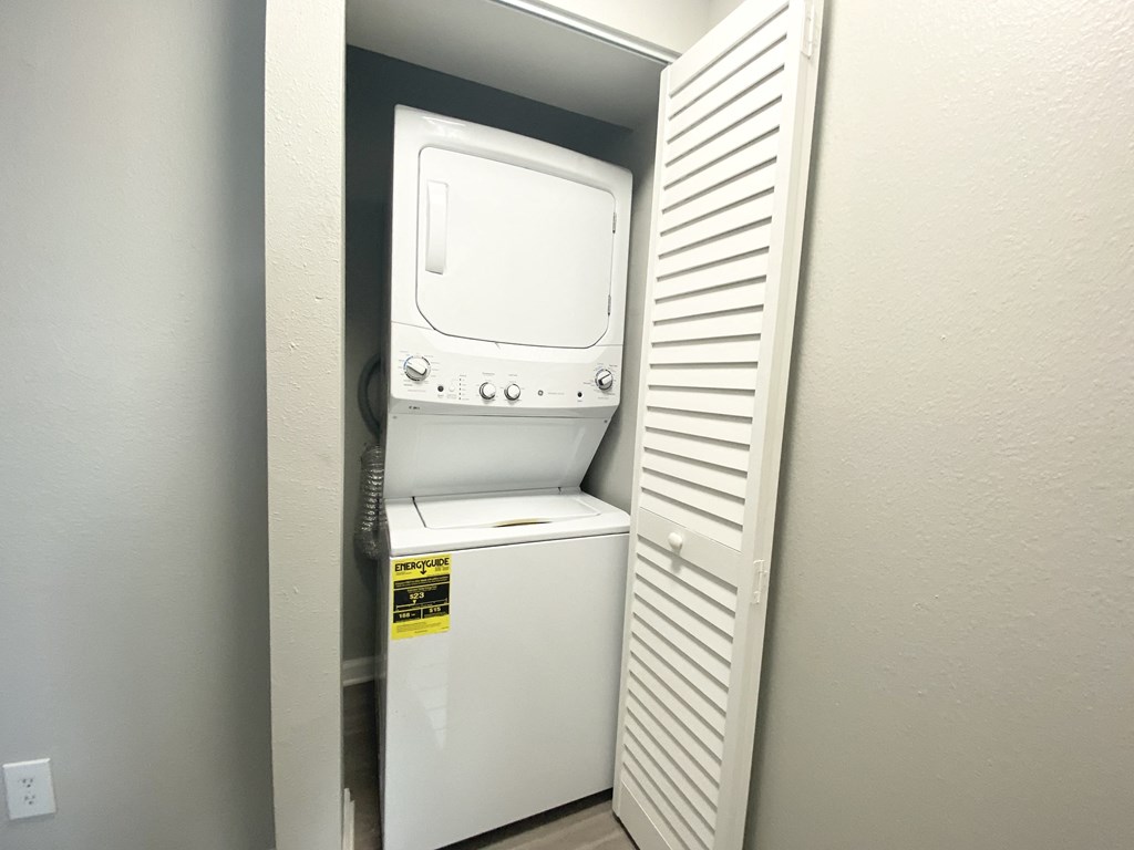 a white washer and dryer in a small closet