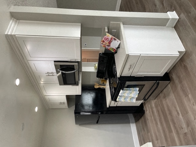 Kitchen with stove, fridge, and microwave