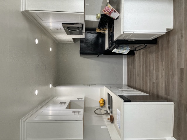 Kitchen with both side which includes the sink and appliances on the opposite side