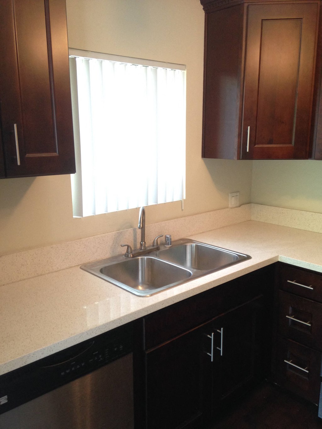 A kitchen with a sink and a window.