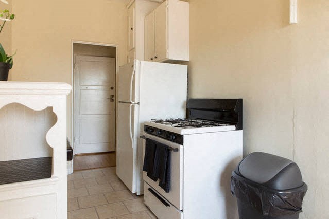 a small kitchen with a stove and a refrigerator
