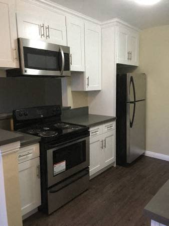 a kitchen with a stove and a refrigerator