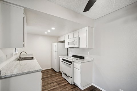a kitchen with white appliances and white cabinets