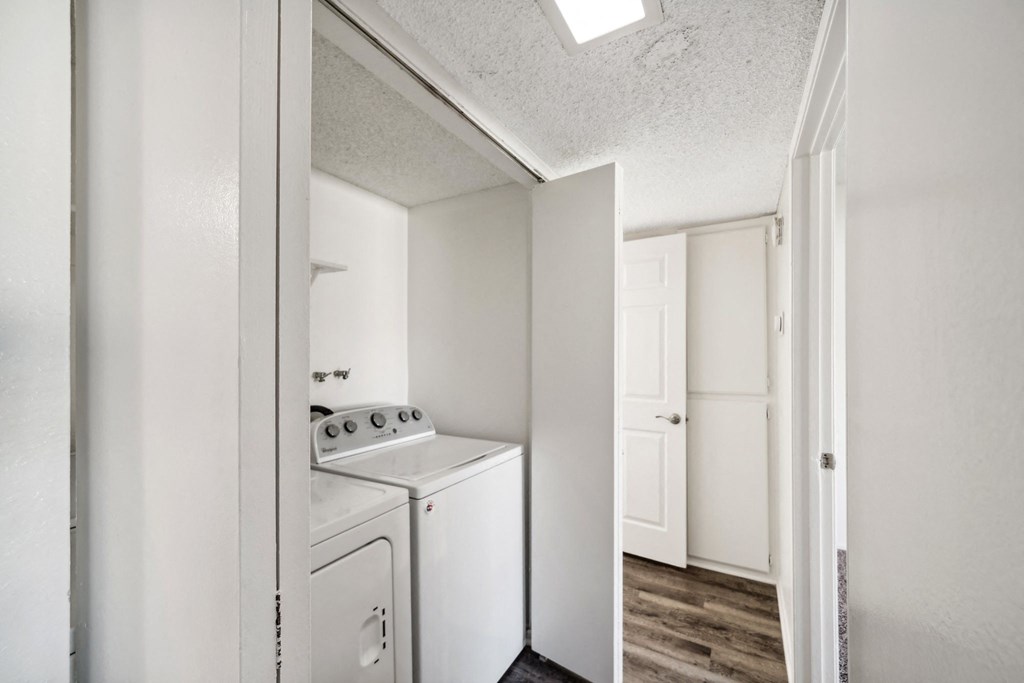 a white kitchen with a white stove and a white refrigerator