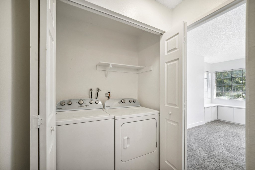 a washer and dryer in a laundry room with a window