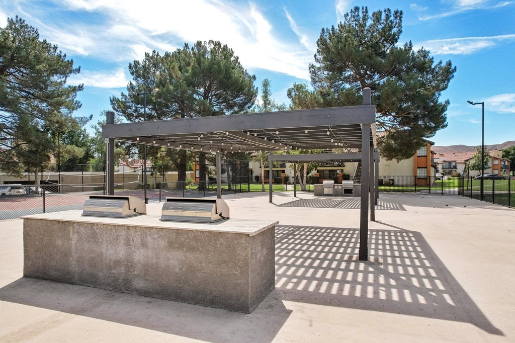a park with benches and a shade