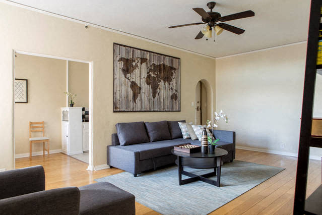 Livingroom with couch, coffee table and entrance of kitchen