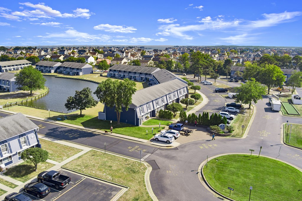 an aerial view of a building next to a body of water