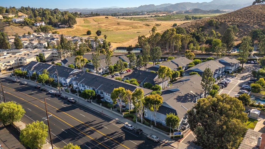 A suburban neighborhood with houses and parked cars.