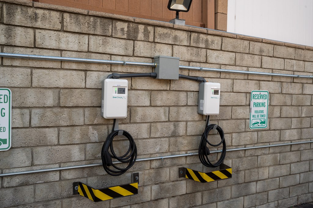Two electric vehicle charging stations on a wall.