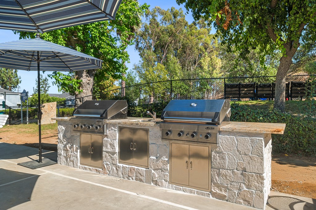 A stone wall with two grills on top.