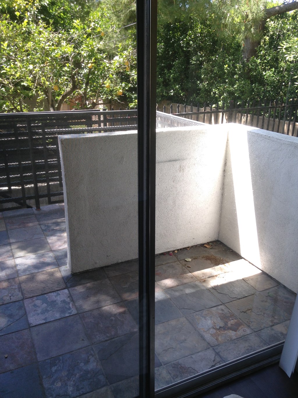 A view of a patio through a glass door.